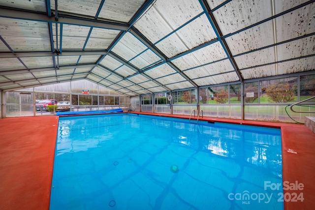 view of swimming pool with glass enclosure