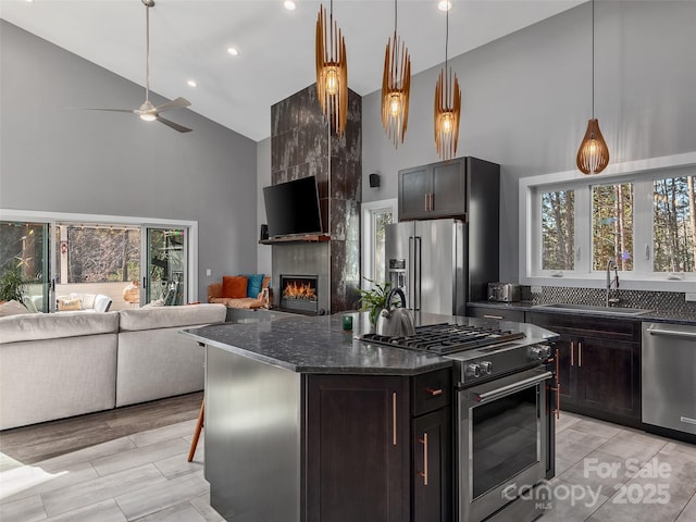 kitchen featuring sink, a breakfast bar area, a center island, high quality appliances, and dark brown cabinetry