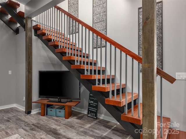 stairway with hardwood / wood-style floors