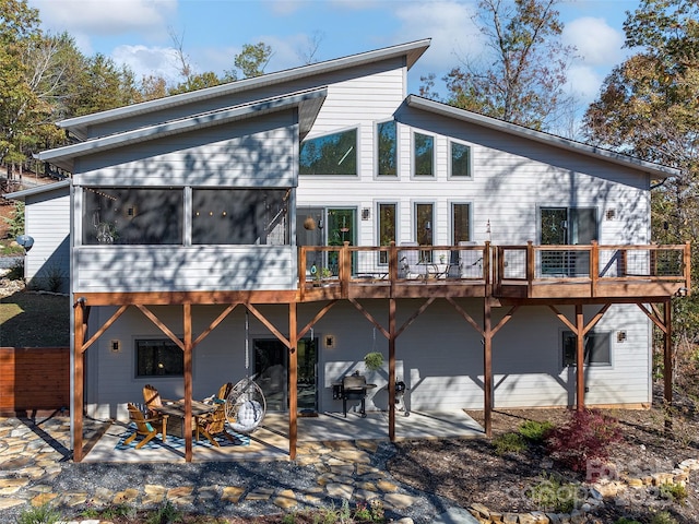 back of house featuring an outdoor fire pit and a patio area