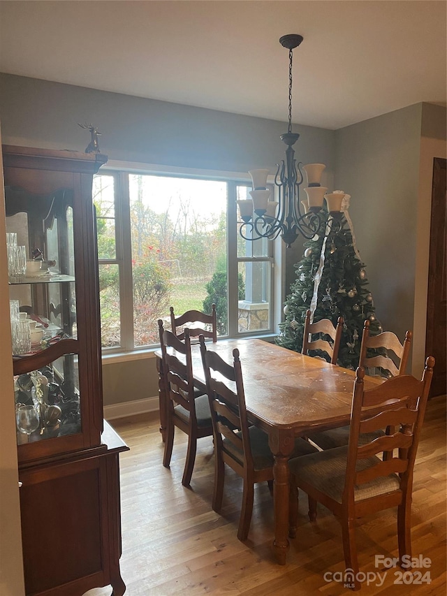 dining area featuring light hardwood / wood-style flooring and an inviting chandelier