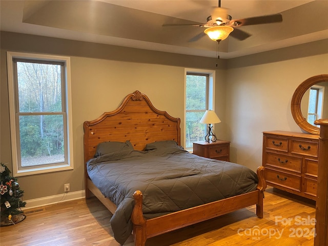 bedroom with ceiling fan and light hardwood / wood-style floors