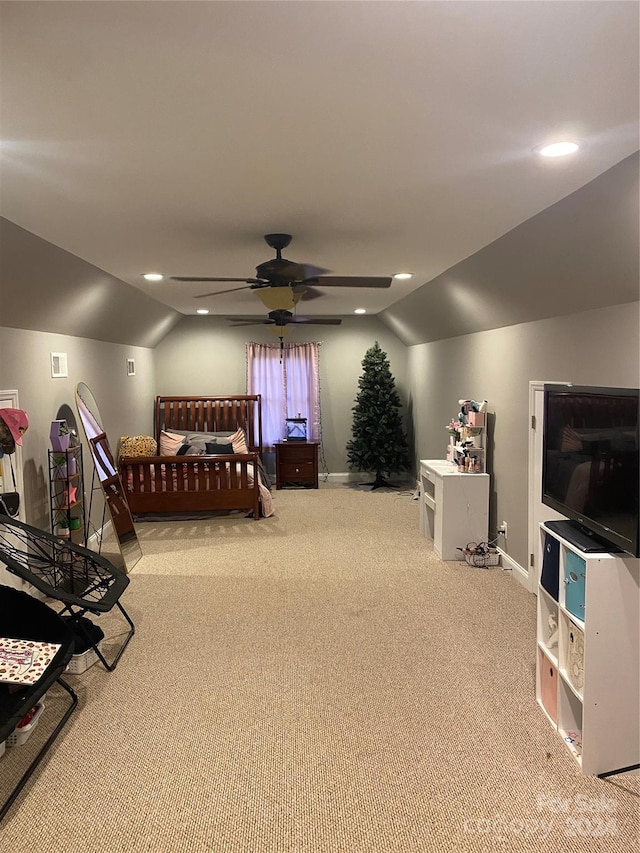 carpeted bedroom with vaulted ceiling and ceiling fan