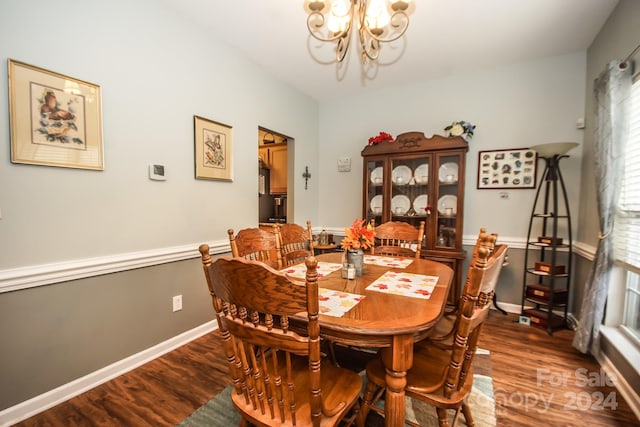 dining room with wood-type flooring and a notable chandelier