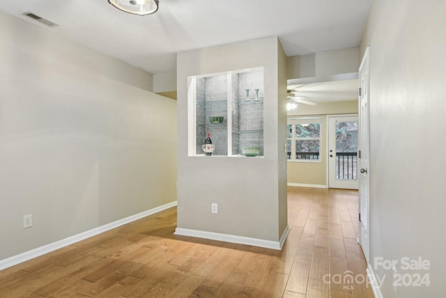 corridor with light hardwood / wood-style flooring