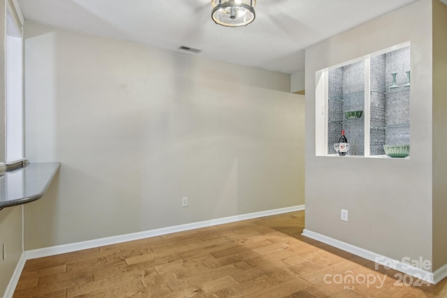 unfurnished room featuring hardwood / wood-style floors