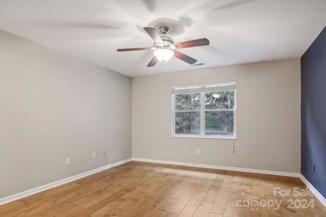 unfurnished room with ceiling fan and light hardwood / wood-style flooring