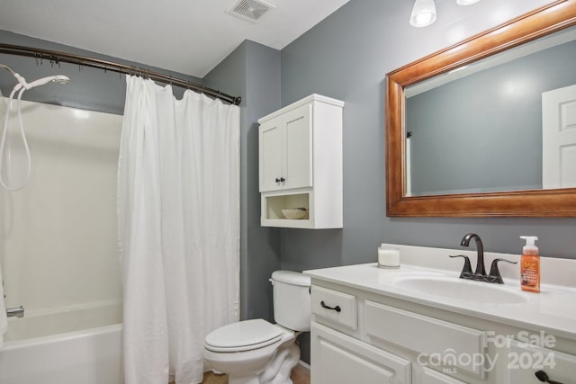 full bathroom featuring vanity, shower / bath combo, and toilet