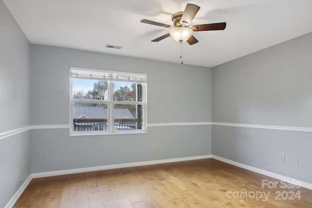 spare room featuring ceiling fan and hardwood / wood-style flooring