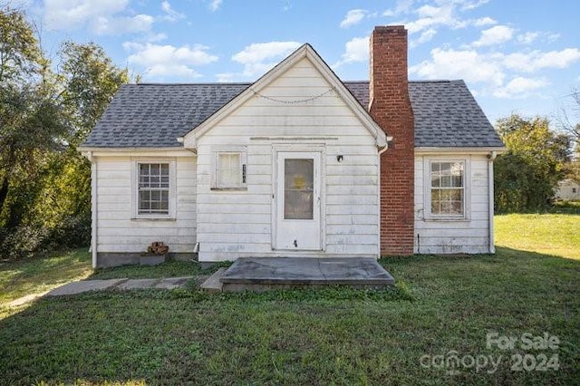 back of house featuring a yard and a patio