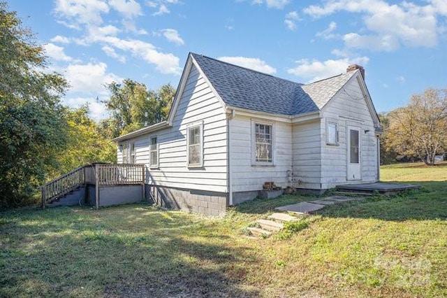 view of property exterior featuring a lawn and a deck