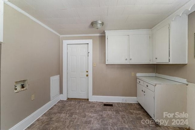 clothes washing area with hookup for a washing machine, cabinets, and ornamental molding