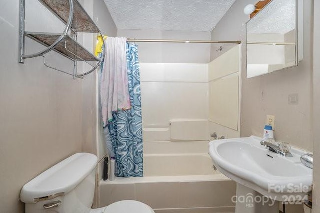 full bathroom with sink, shower / bath combo, a textured ceiling, and toilet