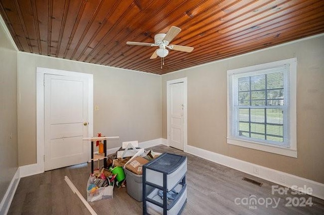 miscellaneous room featuring dark hardwood / wood-style floors, ceiling fan, and wood ceiling