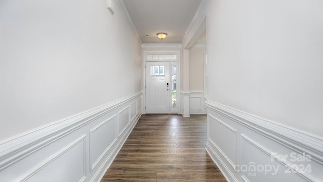 doorway with dark wood-type flooring and ornamental molding