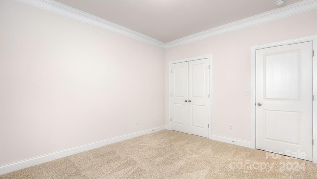 unfurnished bedroom with light colored carpet and ornamental molding