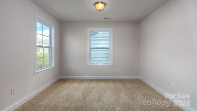 empty room featuring light colored carpet