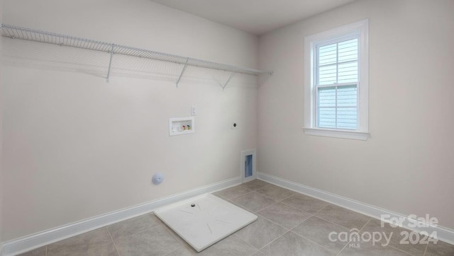 washroom with hookup for a gas dryer, hookup for a washing machine, light tile patterned floors, and hookup for an electric dryer