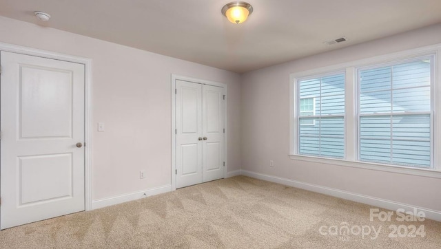 unfurnished bedroom with light carpet