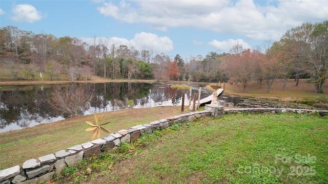 exterior space with a lawn and a water view