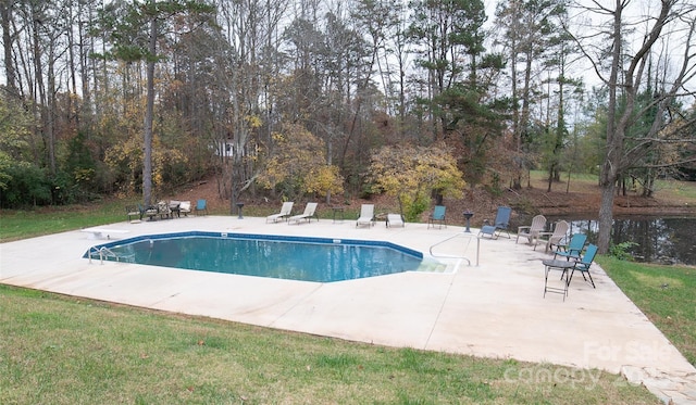 view of pool with a patio, a diving board, and a lawn