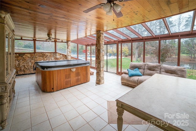 unfurnished sunroom featuring wooden ceiling, ceiling fan, and a jacuzzi