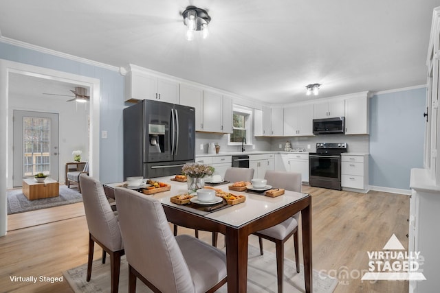 kitchen featuring white cabinets, tasteful backsplash, light hardwood / wood-style flooring, and appliances with stainless steel finishes