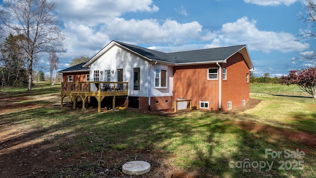 back of property featuring a deck and a lawn