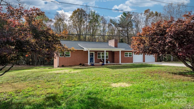 ranch-style house with covered porch, a front lawn, and a garage