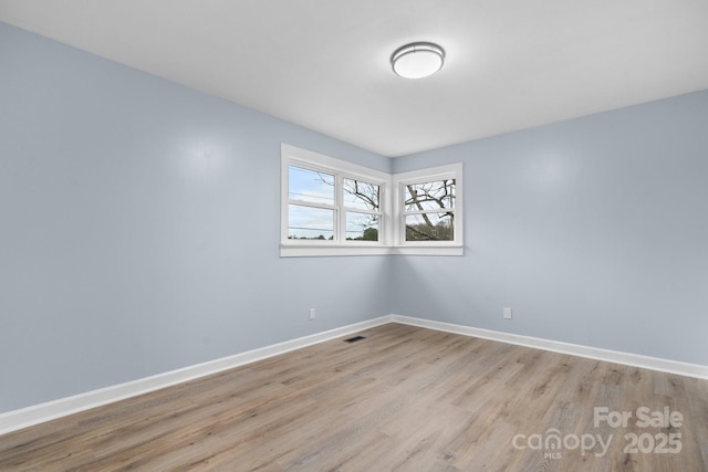 spare room with light hardwood / wood-style floors