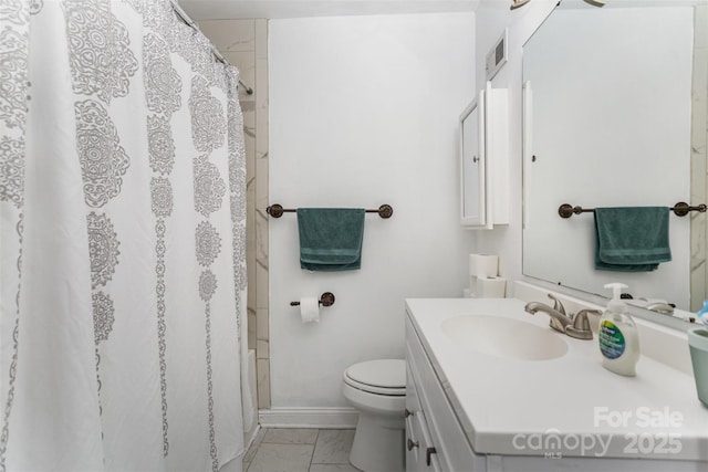 bathroom featuring tile patterned flooring, vanity, and toilet