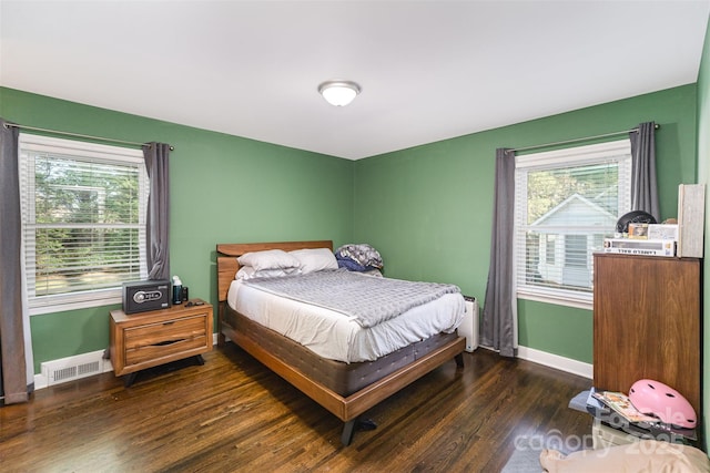 bedroom with dark hardwood / wood-style floors