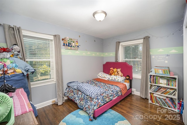 bedroom with dark hardwood / wood-style floors