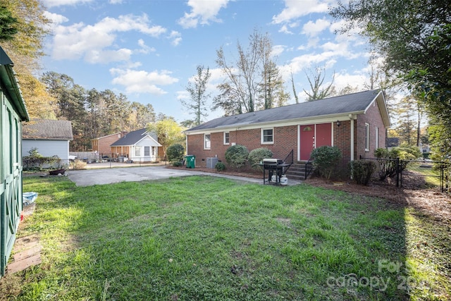 back of property featuring a patio area and a yard