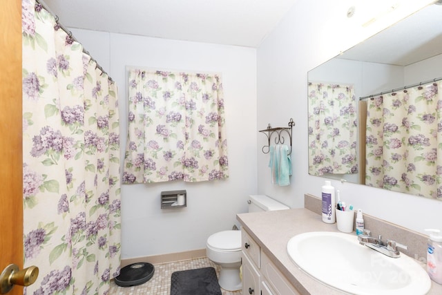 bathroom featuring tile patterned flooring, vanity, and toilet