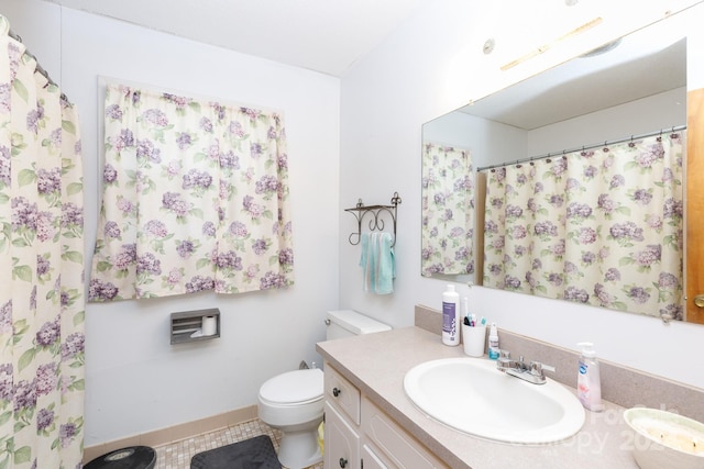 bathroom featuring tile patterned floors, vanity, and toilet