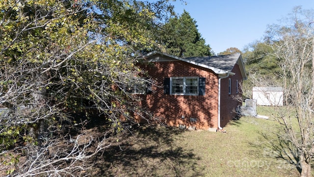 view of property exterior with a lawn