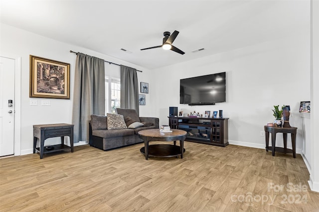 living room with ceiling fan and light wood-type flooring