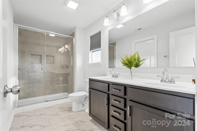 bathroom with vanity, toilet, and walk in shower