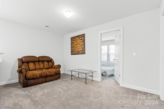 sitting room featuring light colored carpet