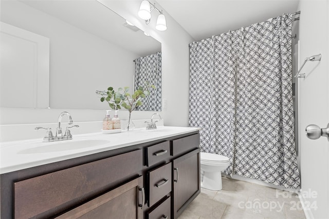 bathroom with tile patterned floors, vanity, and toilet