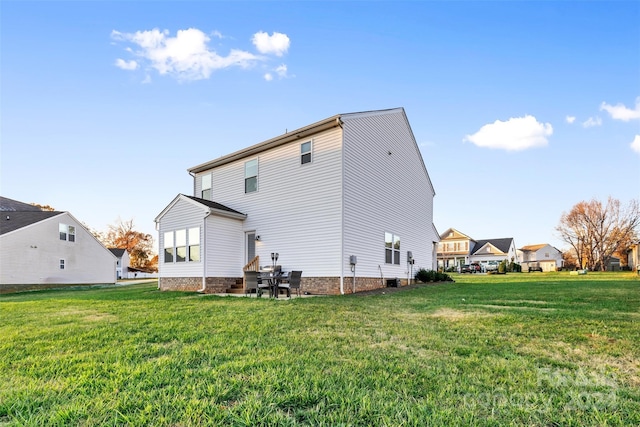 rear view of house featuring a lawn