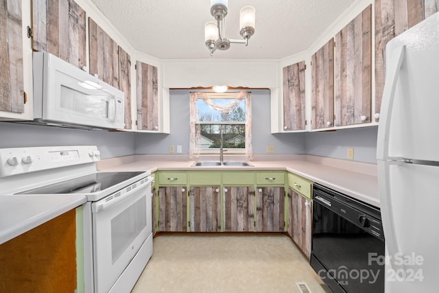 kitchen featuring a textured ceiling, sink, white appliances, and ornamental molding