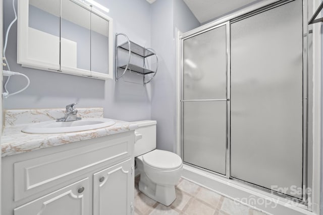 bathroom with toilet, vanity, and walk in shower