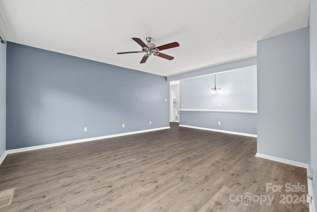 spare room featuring wood-type flooring, a textured ceiling, and ceiling fan