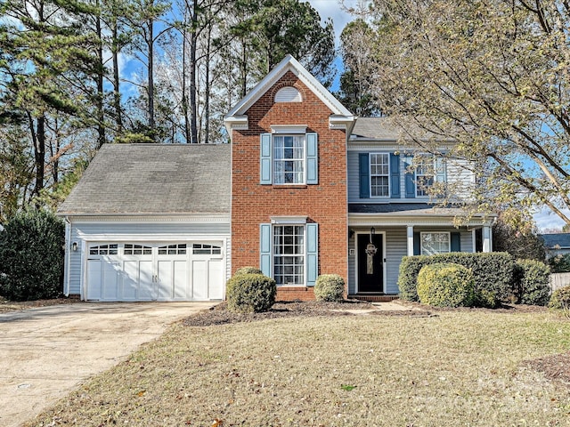 view of property featuring a garage and a front lawn