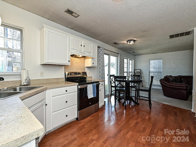 kitchen featuring stainless steel range with electric cooktop, white cabinets, sink, a textured ceiling, and dark hardwood / wood-style flooring