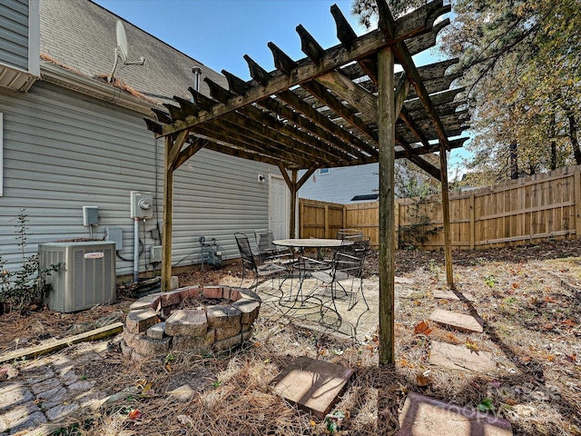 view of patio / terrace with central AC unit, a pergola, and an outdoor fire pit