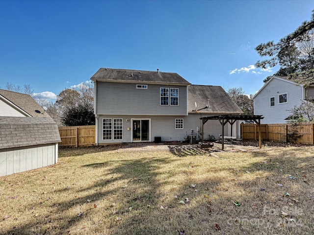 back of property with a pergola, a yard, and a patio