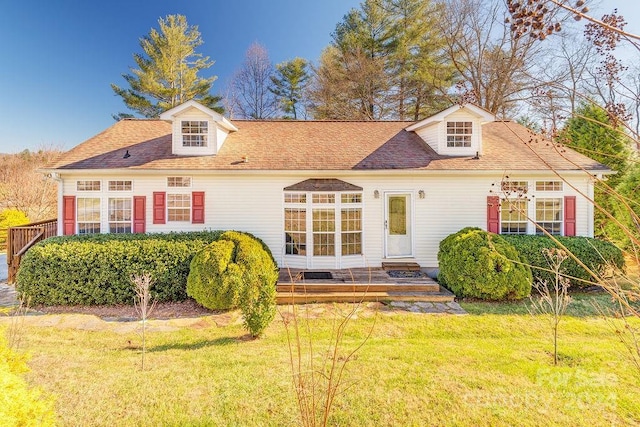 rear view of house featuring a lawn